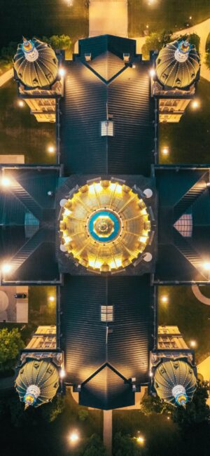 An overhead drone shot of a large church rooftop at night